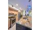 Well-equipped kitchen featuring stainless appliances, granite countertops, and a breakfast bar for casual dining at 659 Garland Cir, Indian Rocks Beach, FL 33785