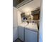 Functional laundry room featuring a washer, dryer, and storage shelves at 659 Garland Cir, Indian Rocks Beach, FL 33785