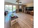 Inviting living room with a corner fireplace, beautiful flooring, and sliding glass doors to the balcony at 659 Garland Cir, Indian Rocks Beach, FL 33785