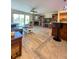 Open-concept living room and kitchen with modern decor, fireplace, and water views at 659 Garland Cir, Indian Rocks Beach, FL 33785