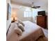 Bright main bedroom featuring a ceiling fan, a large window with blinds, and a wooden dresser at 659 Garland Cir, Indian Rocks Beach, FL 33785