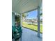 Covered patio with green chairs overlooking a canal and boat dock at 659 Garland Cir, Indian Rocks Beach, FL 33785