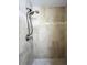 Tiled walk-in shower with neutral stone large format tiles and a dual shower head fixture at 659 Garland Cir, Indian Rocks Beach, FL 33785