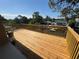 Wooden balcony boasts a private canal view and lush trees for a peaceful retreat at 7330 New York Ave, Hudson, FL 34667