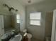 Bathroom features vanity with granite countertop, tile flooring and neutral paint at 7330 New York Ave, Hudson, FL 34667