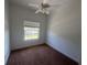 A bedroom featuring neutral walls, a window for natural light, and a ceiling fan at 7330 New York Ave, Hudson, FL 34667