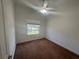 A bedroom with neutral walls, carpet flooring, a ceiling fan and natural light from the window at 7330 New York Ave, Hudson, FL 34667