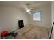 Bedroom with ceiling fan and window awaits personal touches and flooring updates at 7330 New York Ave, Hudson, FL 34667