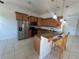 Well-lit kitchen with stainless steel appliances and breakfast bar seating at 7330 New York Ave, Hudson, FL 34667