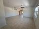 Spacious living room with tile flooring, crown molding, and ceiling fans at 7330 New York Ave, Hudson, FL 34667