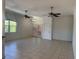 Bright and airy living room features tile floors, ceiling fans and decorative glass doors at 7330 New York Ave, Hudson, FL 34667