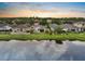 Aerial view of a backyard overlooking a tranquil pond, providing a serene and private setting at sunset at 816 College Chase Dr, Ruskin, FL 33570