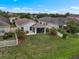 Aerial view of a backyard overlooking a tranquil pond, providing a serene and private setting at 816 College Chase Dr, Ruskin, FL 33570