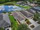 Beautiful aerial view of homes and pond with lovely landscaping on a sunny day at 816 College Chase Dr, Ruskin, FL 33570