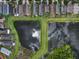 A lovely aerial view shows homes bordering two ponds in a beautiful neighborhood at 816 College Chase Dr, Ruskin, FL 33570