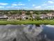 Aerial view of a backyard overlooking a tranquil pond, providing a serene and private setting at 816 College Chase Dr, Ruskin, FL 33570