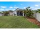 A well-maintained backyard features a screened-in lanai and lush landscaping, perfect for outdoor living at 816 College Chase Dr, Ruskin, FL 33570