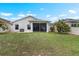 A well-maintained backyard features a screened-in lanai and lush landscaping, perfect for outdoor living at 816 College Chase Dr, Ruskin, FL 33570