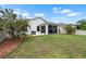 A well-maintained backyard features a screened-in lanai and lush landscaping, perfect for outdoor living at 816 College Chase Dr, Ruskin, FL 33570