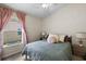 Cozy bedroom with a window, soft lighting, and comfortable bedding at 816 College Chase Dr, Ruskin, FL 33570