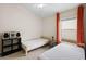 Bedroom featuring twin beds, a window with orange curtains, and neutral walls at 816 College Chase Dr, Ruskin, FL 33570