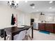 Open-concept kitchen featuring dark wood cabinets, stainless steel appliances, and a dining area at 816 College Chase Dr, Ruskin, FL 33570