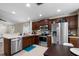 Well-lit kitchen featuring modern stainless appliances, granite countertops, and tile backsplash at 816 College Chase Dr, Ruskin, FL 33570