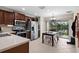 Modern kitchen with stainless steel appliances, breakfast nook, and an adjacent sliding door at 816 College Chase Dr, Ruskin, FL 33570
