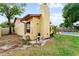 The property features a lush green yard with a pool and functional pool equipment area on the side at 8315 W Elm St, Tampa, FL 33615