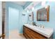 Bright bathroom featuring a modern double vanity with wood cabinets, sleek white countertop and decorative starfish accent at 8315 W Elm St, Tampa, FL 33615