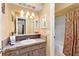 Bathroom with a vanity, mirror, and a shower with curtain at 8315 W Elm St, Tampa, FL 33615