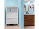 Bright blue bathroom featuring a cabinet and a double sink vanity at 8315 W Elm St, Tampa, FL 33615