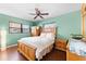 Bedroom featuring a wooden bed, green walls, and a ceiling fan at 8315 W Elm St, Tampa, FL 33615