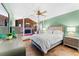 Stylishly decorated bedroom with tile flooring, a cozy bed, a fireplace and a dresser with mirror at 8315 W Elm St, Tampa, FL 33615