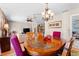 Open dining area with wood table, chandelier, and adjacent living room at 8315 W Elm St, Tampa, FL 33615