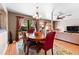 Spacious dining area with hardwood floors, views of the backyard, and access to the living room at 8315 W Elm St, Tampa, FL 33615