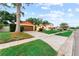 Eye-level view of a home exterior with a well-groomed lawn, mature tree, and paved walkways at 8315 W Elm St, Tampa, FL 33615