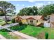 Inviting one-story home with manicured lawn, flowering bushes, and attached garage at 8315 W Elm St, Tampa, FL 33615