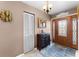 Elegant foyer featuring a decorative front door, stylish lighting, and a beautiful cabinet and mirror at 8315 W Elm St, Tampa, FL 33615