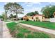 Charming single-story home with a well-manicured lawn and mature trees, creating a welcoming curb appeal at 8315 W Elm St, Tampa, FL 33615