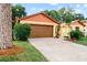 Well-kept home featuring an attached garage and tidy landscaping, enhancing its curb appeal at 8315 W Elm St, Tampa, FL 33615