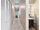 Hallway with large closets leading to bathroom featuring vanity at 8315 W Elm St, Tampa, FL 33615