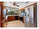 Updated kitchen with stainless steel refrigerator, tiled floors, wood cabinets, and modern appliances at 8315 W Elm St, Tampa, FL 33615