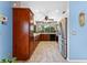 Spacious kitchen featuring stainless steel appliances, wooden cabinets, and a ceiling fan at 8315 W Elm St, Tampa, FL 33615