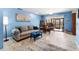 Bright living room with tiled floors, neutral sofa, dining area, and sliding glass doors at 8315 W Elm St, Tampa, FL 33615