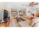 Bright and airy living room showcasing a large sectional sofa, hardwood floors, and an open layout to the dining area at 8315 W Elm St, Tampa, FL 33615