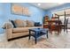 Cozy living area with comfortable seating, a small table, and sliding glass doors to a screened patio at 8315 W Elm St, Tampa, FL 33615