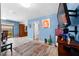 Open-concept living space with tiled floors, television, and adjacent kitchen area at 8315 W Elm St, Tampa, FL 33615