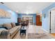 Inviting living room with tiled floors, comfortable seating, and sliding glass doors to the backyard at 8315 W Elm St, Tampa, FL 33615