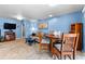 Cozy living room with blue walls, tiled floors, dining table, and comfortable sofa at 8315 W Elm St, Tampa, FL 33615